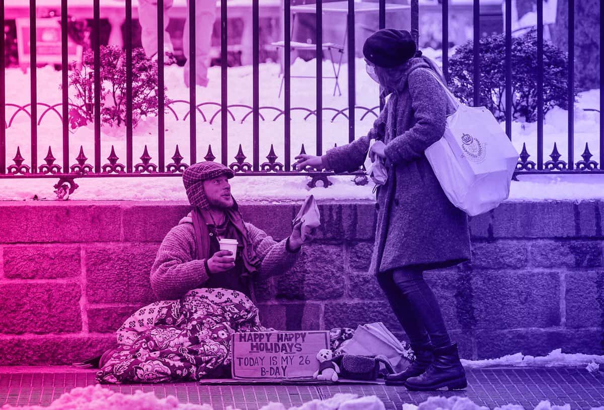 altruistic female giving homeless man money for social media validation