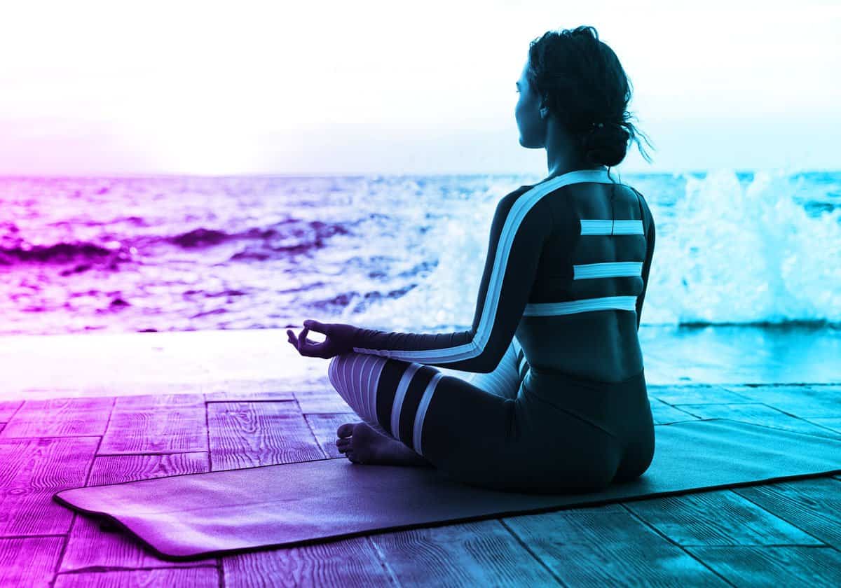 woman healing from abuse meditation on beach