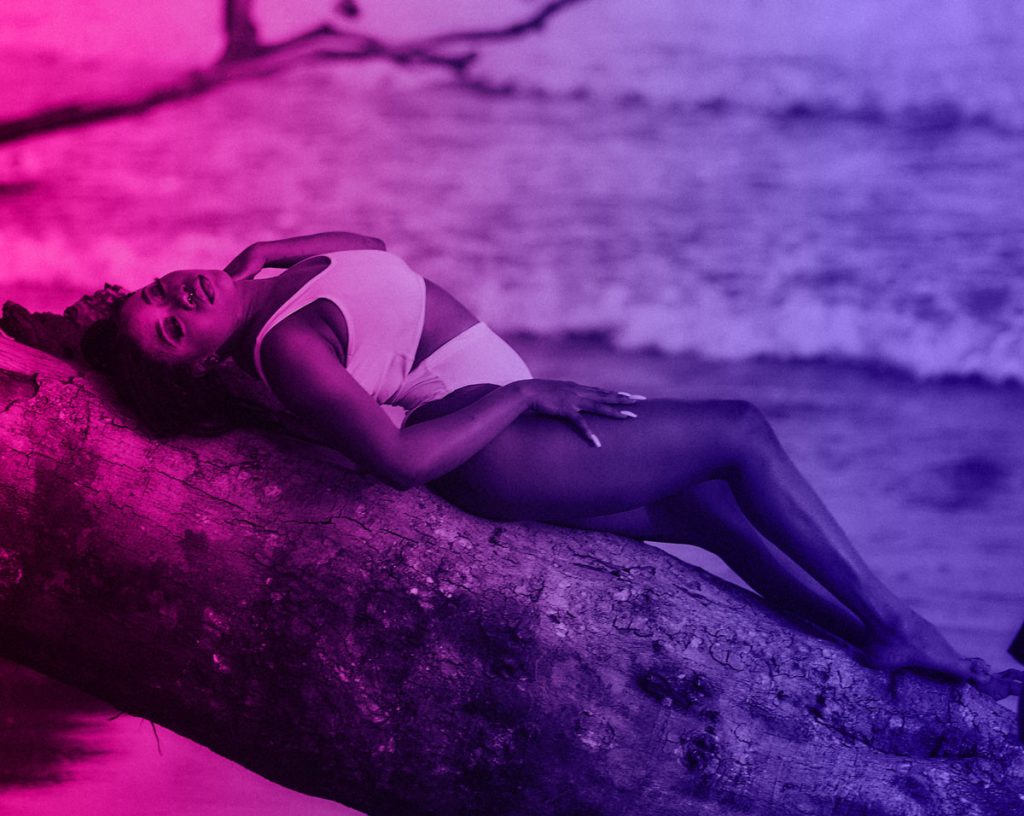 beautiful sexy woman poses on beach to get validation through her looks