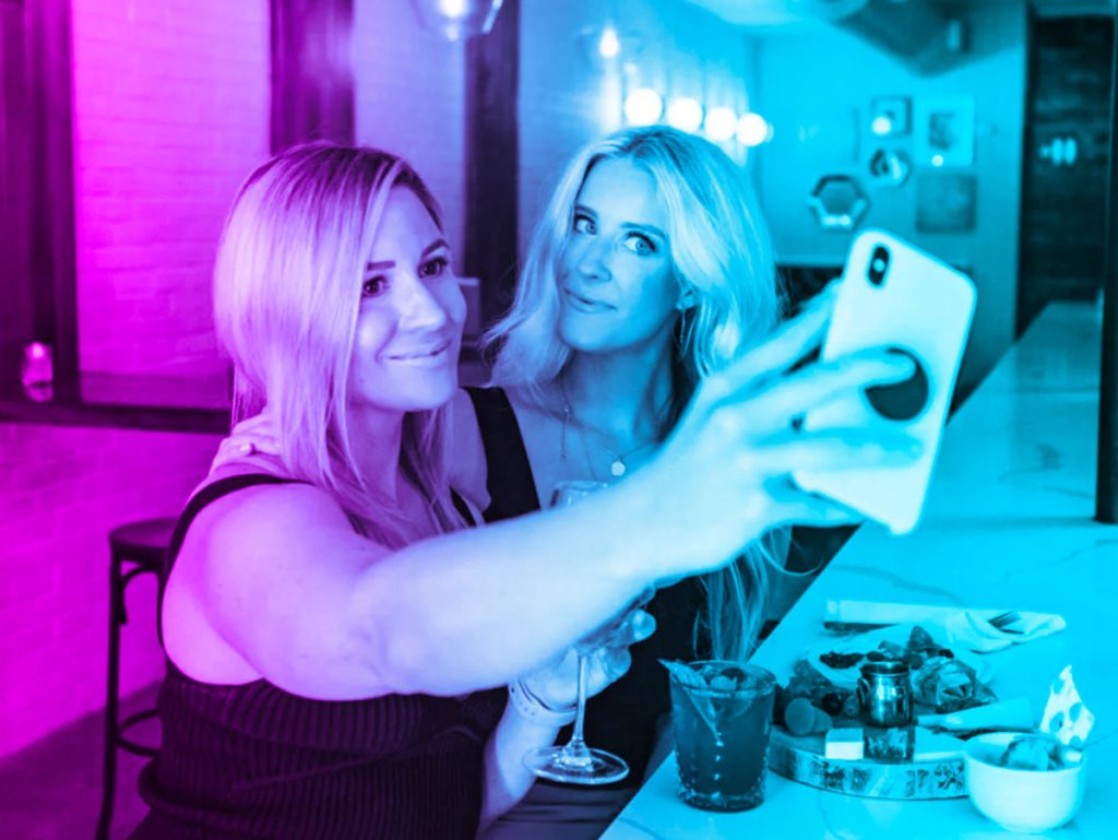 fake friendships taking selfie for social media to gain validation