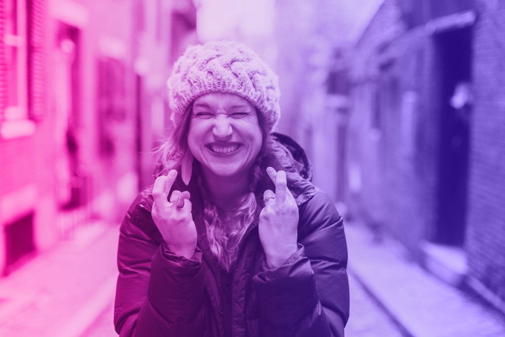 woman exciting about ex returning and crossing her fingers it works this time.
