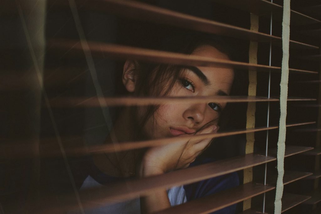Depressed and looking through the window