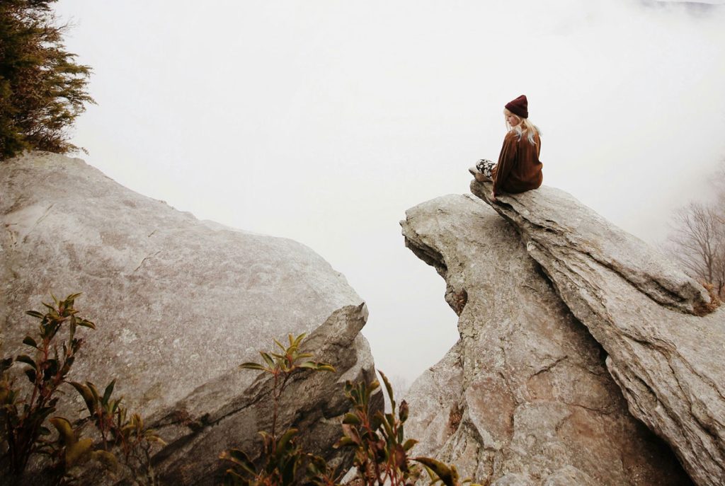 woman self reflecting on her toxic relationship and healing on a mountain top
